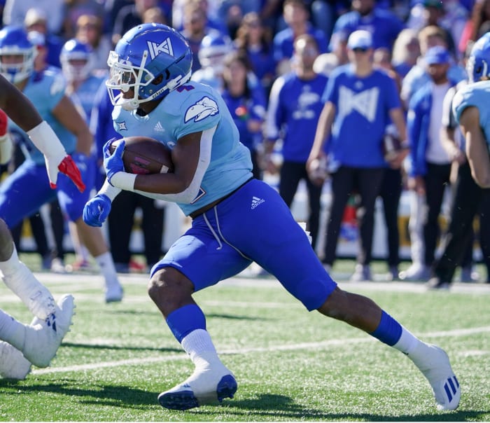 Oct 16, 2021; Lawrence, Kansas, USA; Kansas Jayhawks running back Devin Neal (4) runs the ball against the Texas Tech Red Raiders during the first half at David Booth Kansas Memorial Stadium. Mandatory Credit: Denny Medley-USA TODAY Sports